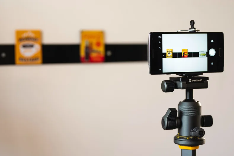 A phone mounted on a tripod for live streaming